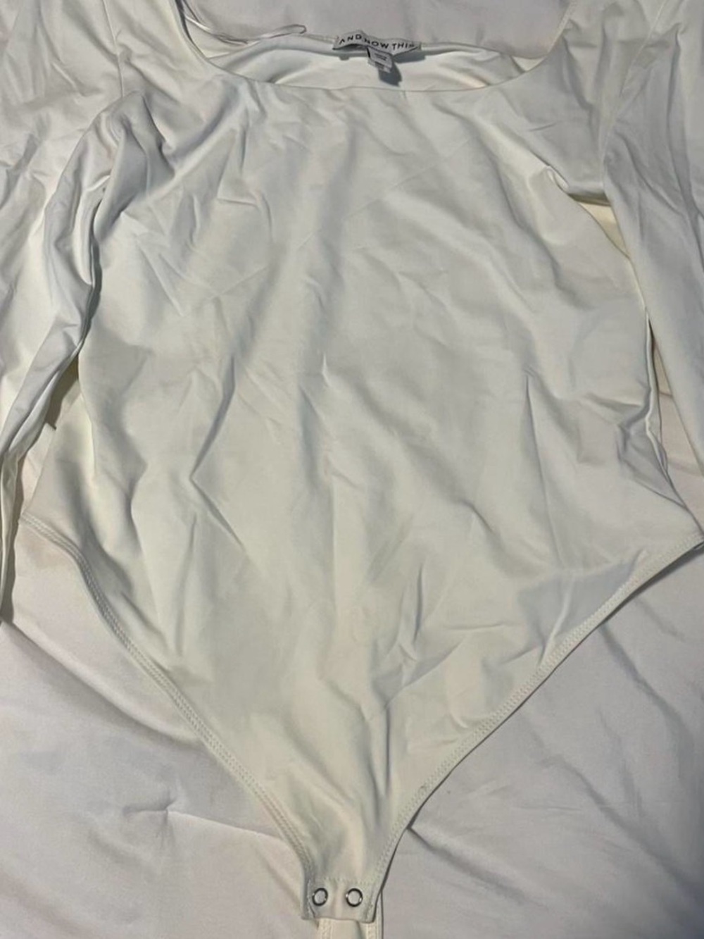 White thong bodysuit with long sleeves